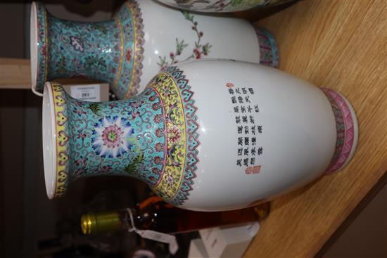A pair of Chinese famille rose vases and another similar (3) Height 36cm